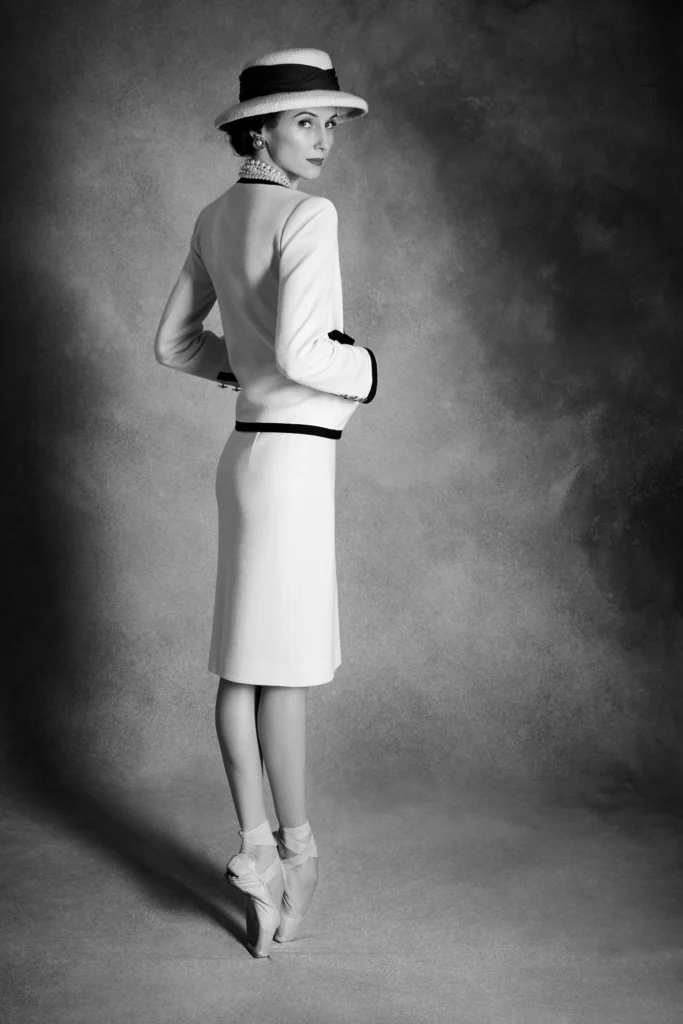 Black-and-white studio portrait of Svetlana Zakharova as Gabrielle Chanel, posed en pointe with an extended leg